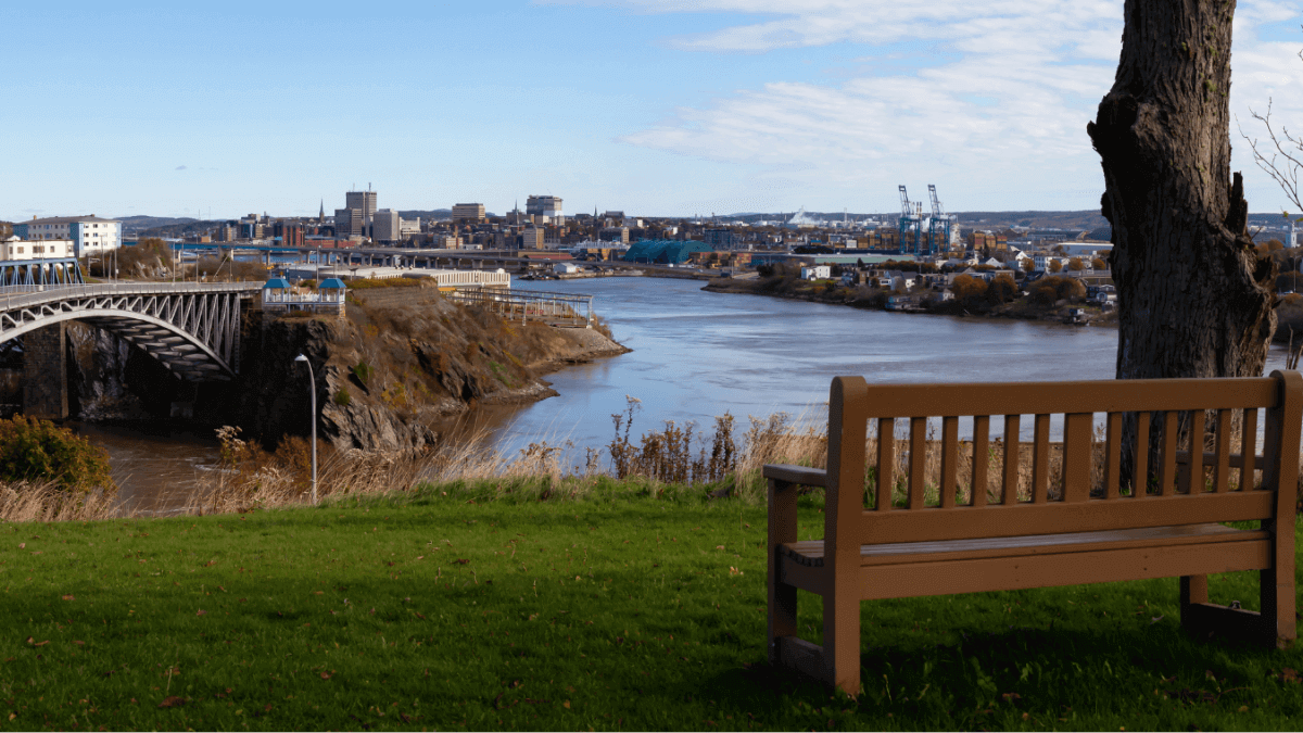 Park bench overlooking river and skyline in Saint John, New Brunswick