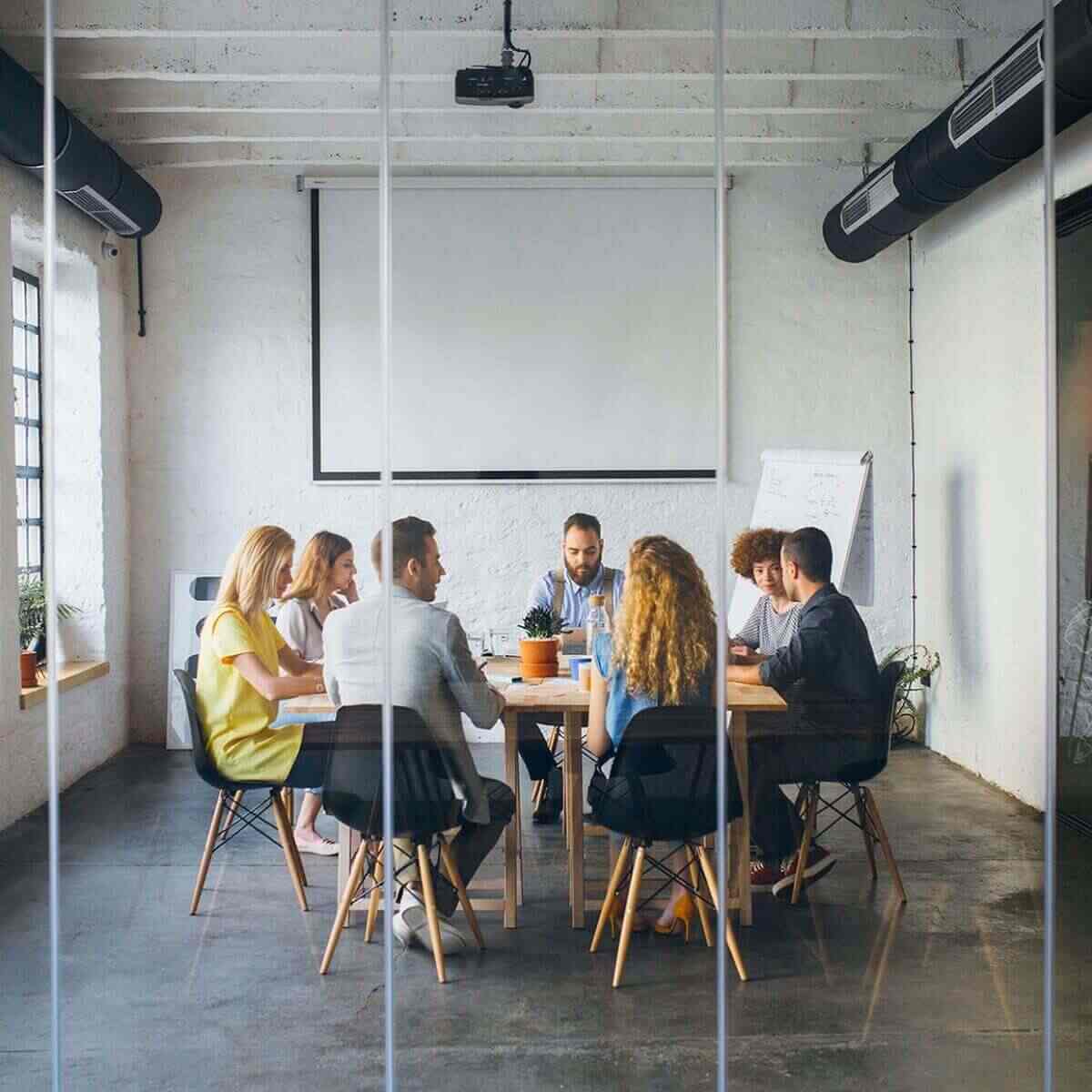 Team having a meeting in boardroom at an office in Canada